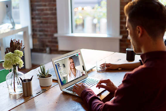 Man at table with laptop